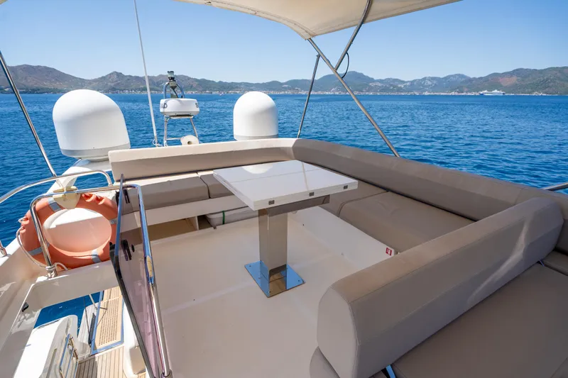 Dudu Yacht Photos Pics Luxurious 2021 Ferretti Yachts 550 deck with seating, table, and ocean view.