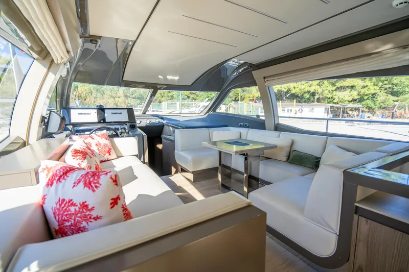 Dudu Yacht Photos Pics Luxurious interior of 2021 Ferretti Yachts 550 with modern seating and navigation equipment.