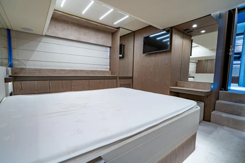 Dudu Yacht Photos Pics Luxurious bedroom interior of 2021 Ferretti Yachts 550, featuring modern design and elegant wood finishes.