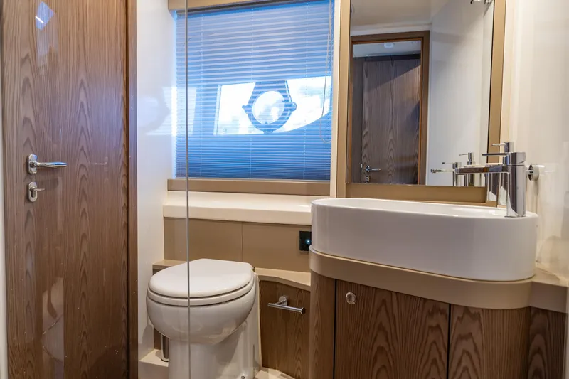 Dudu Yacht Photos Pics Luxurious bathroom in 2021 Ferretti Yachts 550, featuring modern fixtures and elegant wood finishes.