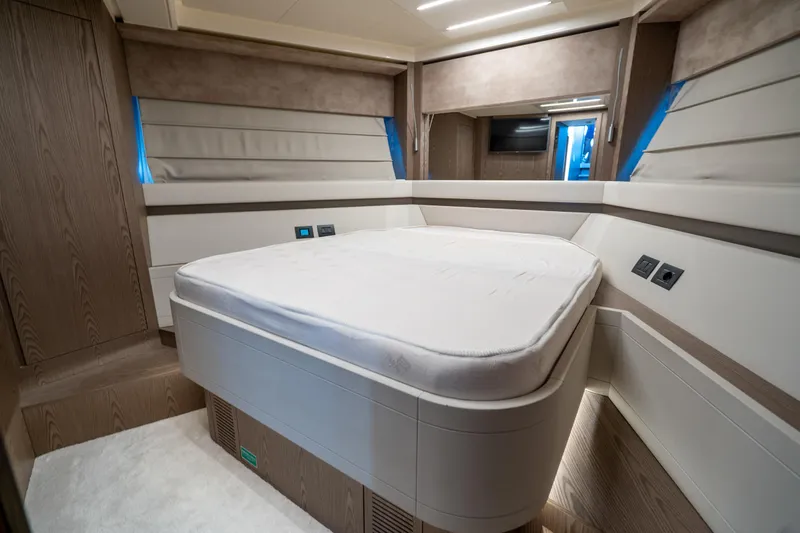 Dudu Yacht Photos Pics Luxurious bedroom interior of 2021 Ferretti Yachts 550, featuring modern design and ambient lighting.