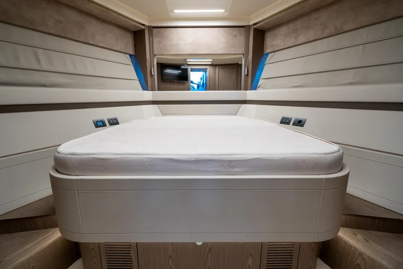 Dudu Yacht Photos Pics Luxurious bedroom interior of 2021 Ferretti Yachts 550, featuring modern design and comfortable bedding.