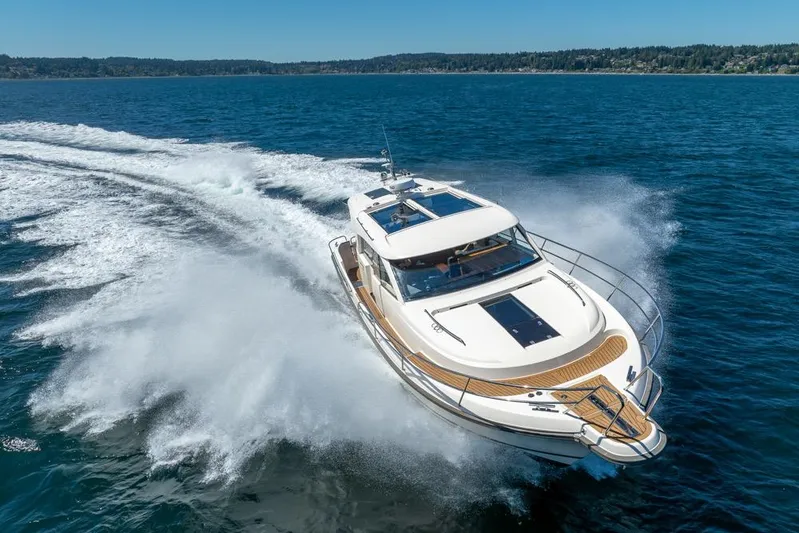 Treasure State Yacht Photos Pics 2022 Nimbus 405 Coup&eacute; yacht cruising on open water, creating a dynamic wake.