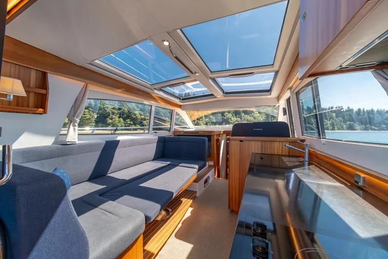 Treasure State Yacht Photos Pics Luxurious interior of 2022 Nimbus 405 Coup&eacute; yacht with panoramic windows and modern design.