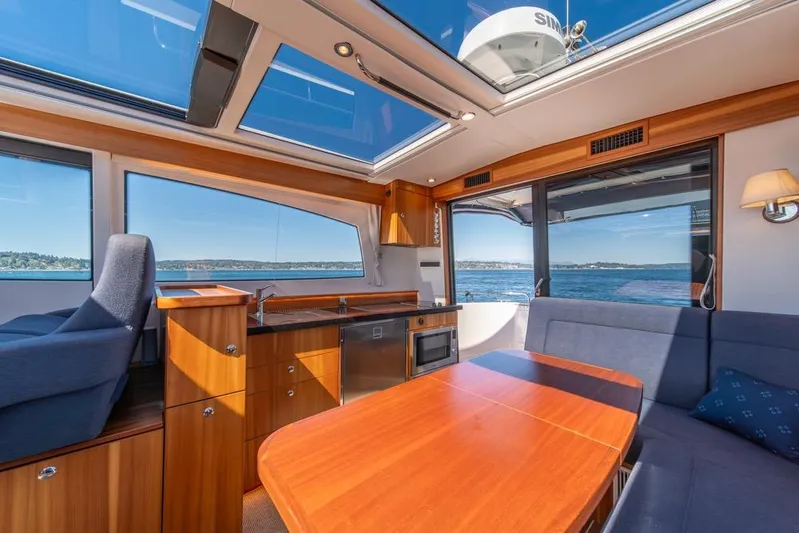 Treasure State Yacht Photos Pics Interior of 2022 Nimbus 405 Coup&eacute; yacht with panoramic windows and modern furnishings.