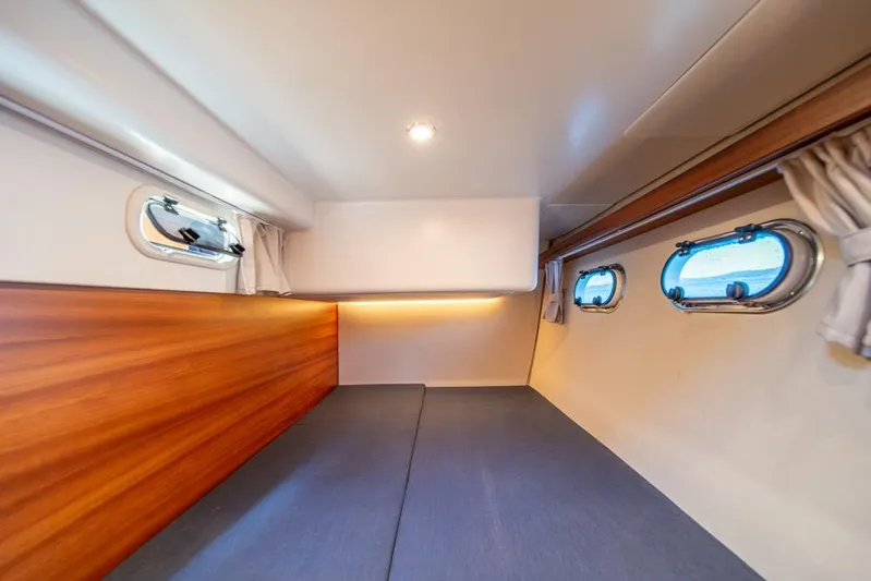 Treasure State Yacht Photos Pics Interior cabin of 2022 Nimbus 405 Coup&eacute; with wood paneling and porthole windows.