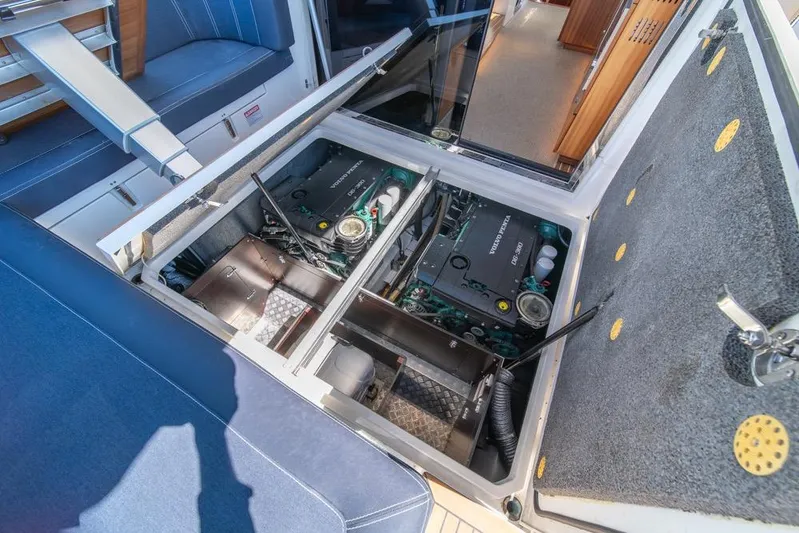 Treasure State Yacht Photos Pics Engine compartment of 2022 Nimbus 405 Coup&eacute; yacht, showcasing mechanical components and seating area.