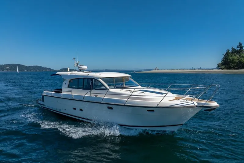 Treasure State Yacht Photos Pics 2022 Nimbus 405 Coup&eacute; yacht cruising on a sunny day in open waters.