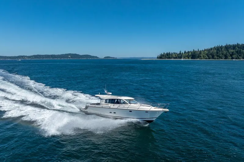 Treasure State Yacht Photos Pics Nimbus 405 Coup&eacute; 2022 cruising on open water under clear blue skies.