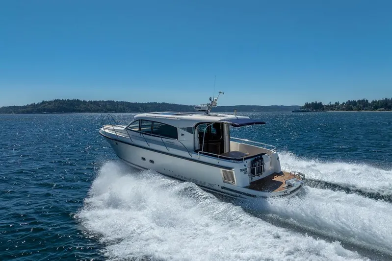 Treasure State Yacht Photos Pics 2022 Nimbus 405 Coup&eacute; cruising on open water under clear blue skies.