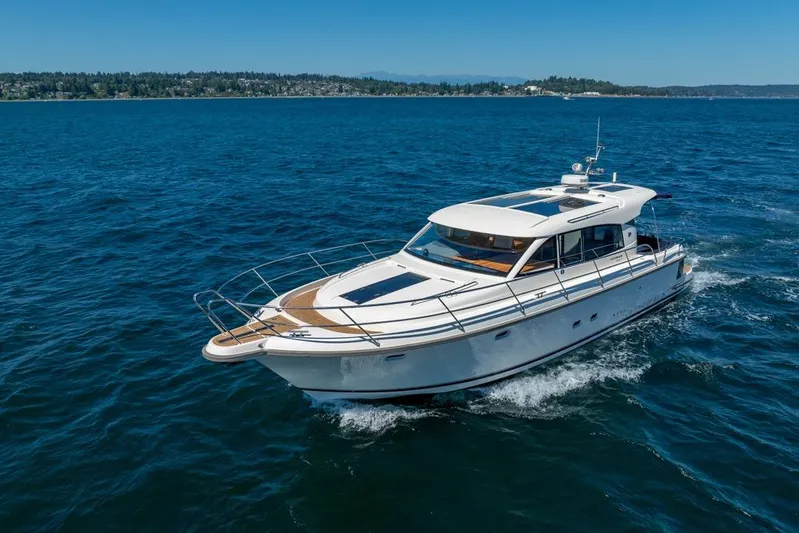 Treasure State Yacht Photos Pics 2022 Nimbus 405 Coup&eacute; yacht cruising on open blue water.