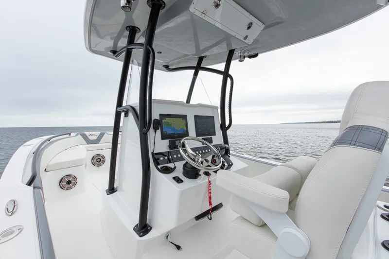  Yacht Photos Pics 2024 Streamline 26 CC boat console with steering wheel and navigation screens on open water.