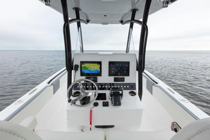  Yacht Photos Pics 2024 Streamline 26 CC boat dashboard with navigation screens on open water.