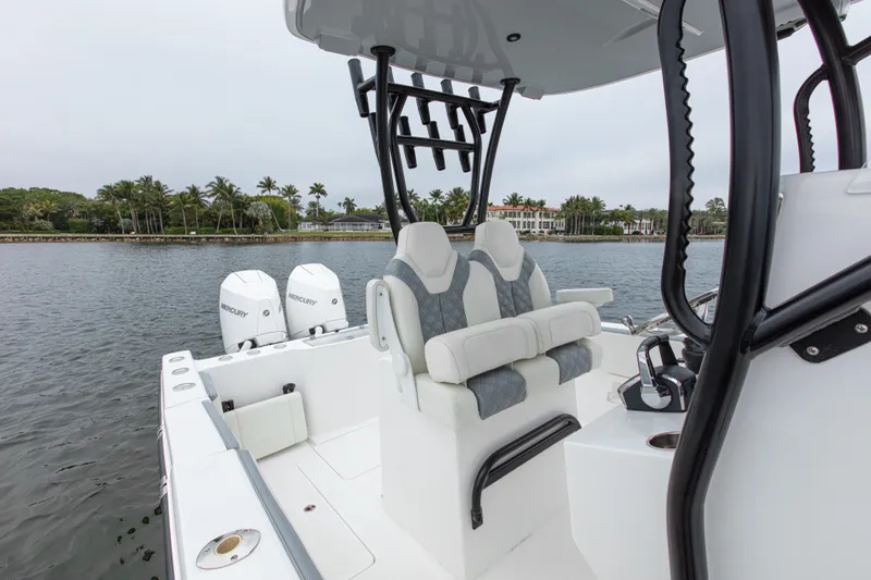  Yacht Photos Pics 2024 Streamline 26 CC boat with dual engines, sleek seating, and rod holders on a calm waterway.