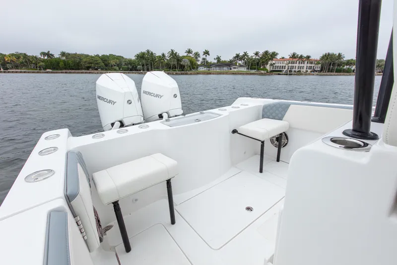  Yacht Photos Pics 2024 Streamline 26 CC boat with dual Mercury engines, white seating, and coastal backdrop.