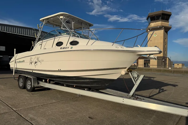  Yacht Photos Pics 2009 Wellcraft 270 Coastal O/B boat on trailer near an airport control tower.