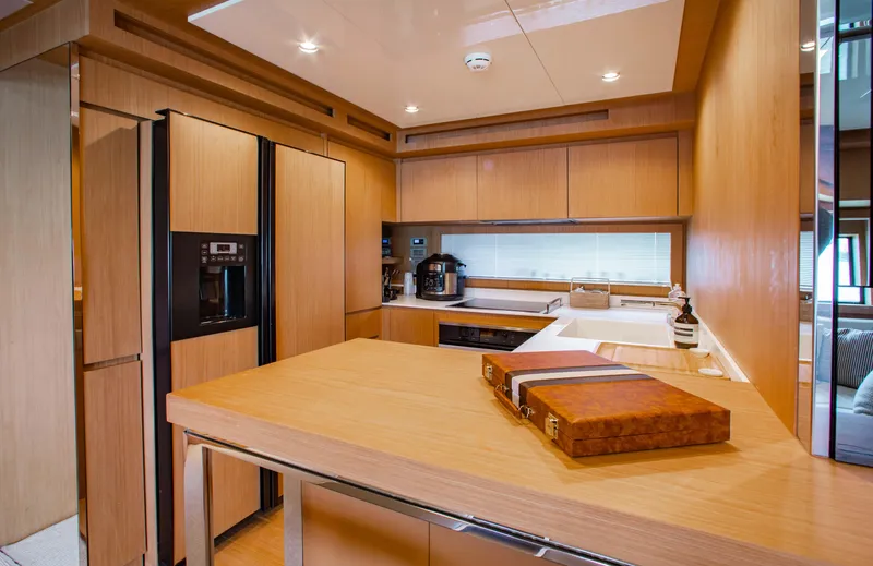 Lady Elkie Yacht Photos Pics Luxurious kitchen interior of 2016 Riva 88' Florida yacht with modern wood finishes.