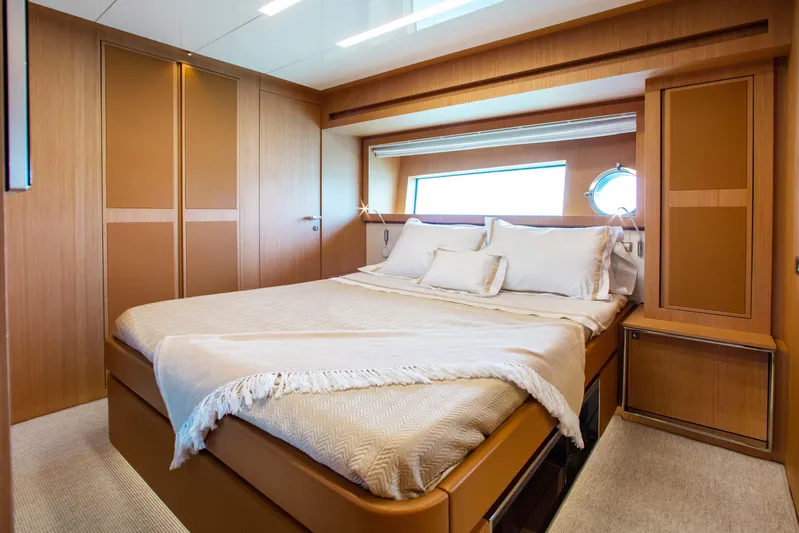 Lady Elkie Yacht Photos Pics Luxurious bedroom interior of 2016 Riva 88' Florida yacht with elegant wood finishes.