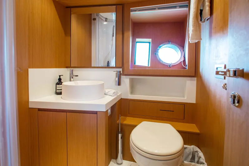 Lady Elkie Yacht Photos Pics Luxurious bathroom in 2016 Riva 88' Florida yacht with modern fixtures and wooden cabinetry.