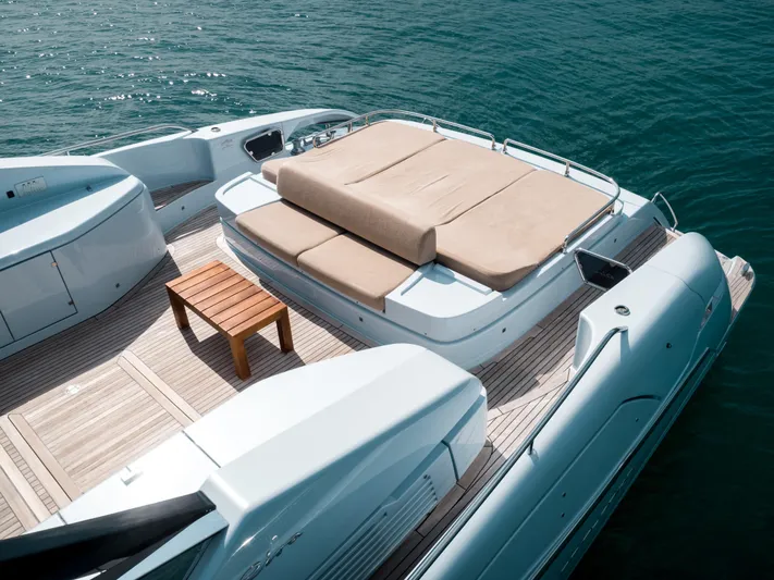 Lady Elkie Yacht Photos Pics Luxury 2016 Riva 88' Florida yacht deck with sunbed and wooden table.
