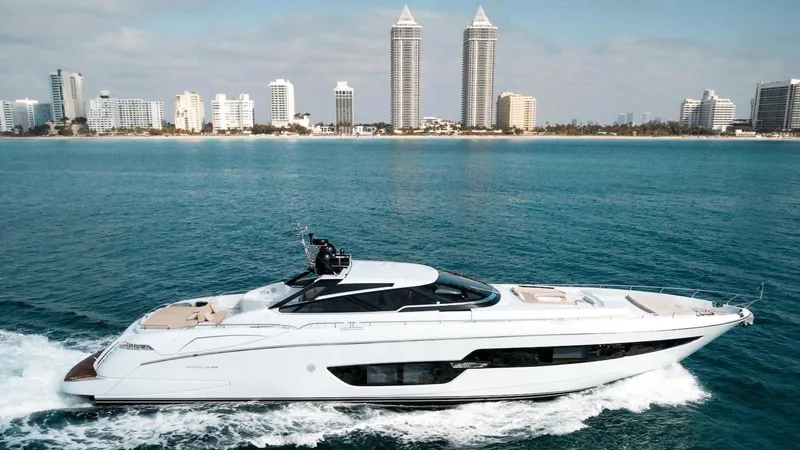 Lady Elkie Yacht Photos Pics Luxury 2016 Riva 88' Florida yacht cruising near a city skyline.