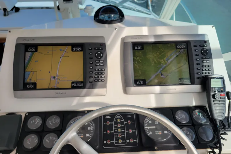 Reely Blessed Yacht Photos Pics Control panel of a 1998 Cabo 31 Express with Tower, featuring Garmin navigation displays.