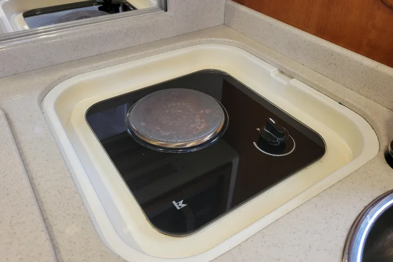 Reely Blessed Yacht Photos Pics 1998 Cabo 31 Express boat stove in compact kitchen area.