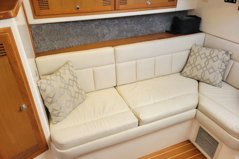 Reely Blessed Yacht Photos Pics 1998 Cabo 31 Express interior with white leather seating and decorative pillows.