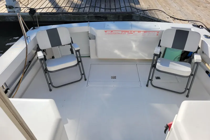 Reely Blessed Yacht Photos Pics 1998 Cabo 31 Express boat deck with two folding chairs and fish ruler.