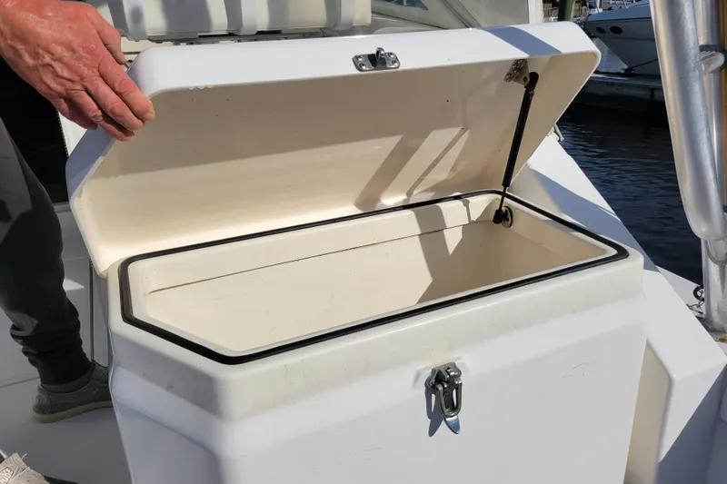 Reely Blessed Yacht Photos Pics Open storage compartment on 1998 Cabo 31 Express boat, showing interior details.