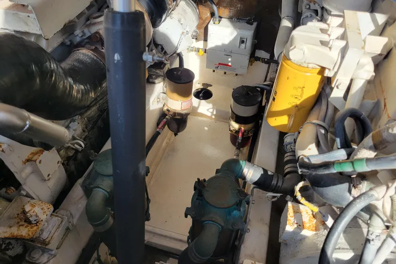 Reely Blessed Yacht Photos Pics Engine room of 1998 Cabo 31 Express with Tower, showcasing mechanical components and piping.