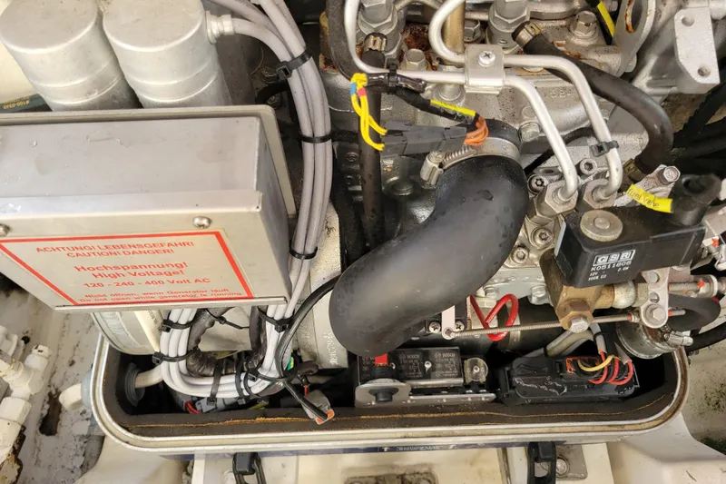 Reely Blessed Yacht Photos Pics Engine compartment of a 1998 Cabo 31 Express with Tower, showing high voltage warning.