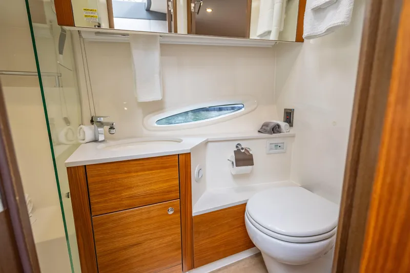 Man Cave Yacht Photos Pics Luxurious 2021 Maritimo X50 yacht bathroom with modern fixtures and wooden cabinetry.