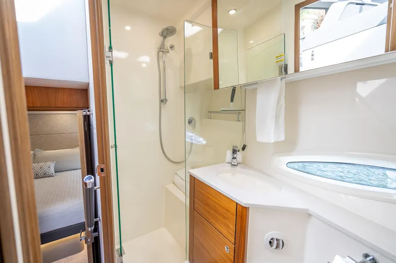 Man Cave Yacht Photos Pics Luxurious bathroom interior of 2021 Maritimo X50 yacht with modern shower and wooden cabinetry.