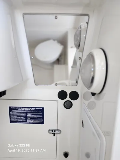  Yacht Photos Pics Interior view of a 2001 Jupiter 31 Open Center Console boat, featuring a mirror and light fixtures.
