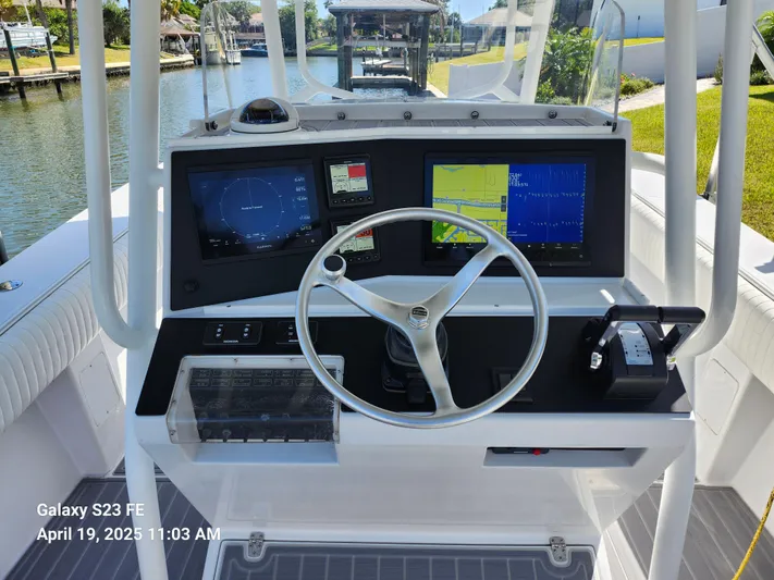  Yacht Photos Pics Center console of a 2001 Jupiter 31 Open boat with navigation screens and steering wheel.