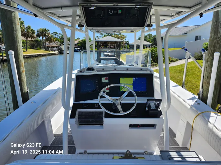  Yacht Photos Pics 2001 Jupiter 31 Open Center Console boat docked by a canal.