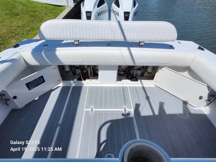  Yacht Photos Pics 2001 Jupiter 31 Open Center Console boat interior with Honda engines, docked by the water.