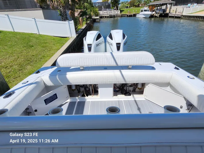  Yacht Photos Pics 2001 Jupiter 31 Open Center Console boat with dual Honda engines docked by a canal.