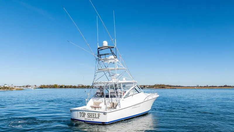  Yacht Photos Pics 2014 Viking 42 Open boat on calm water under clear blue sky.
