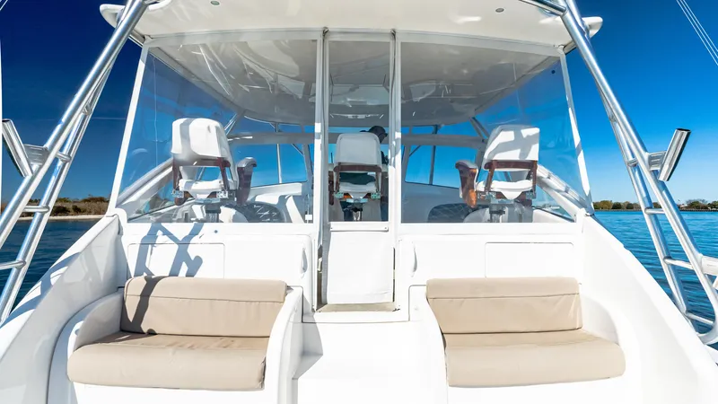  Yacht Photos Pics 2014 Viking 42 Open yacht cockpit with seating and helm, under clear blue sky.