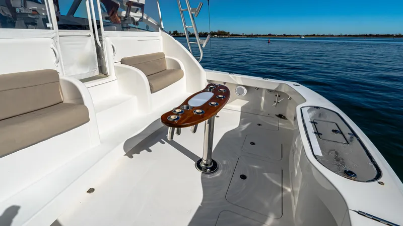 Yacht Photos Pics 2014 Viking 42 Open yacht deck with seating and table, overlooking calm waters.
