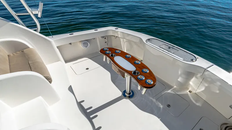  Yacht Photos Pics 2014 Viking 42 Open yacht cockpit with wooden table, surrounded by calm blue water.
