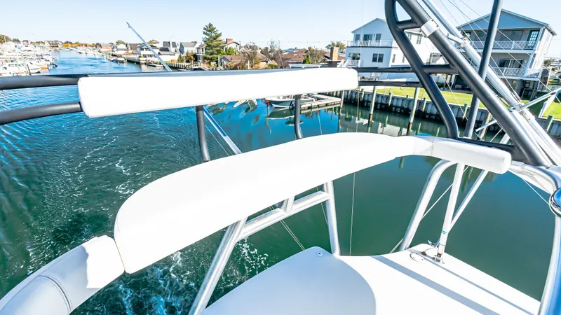  Yacht Photos Pics 2014 Viking 42 Open yacht with white seating, cruising through a scenic waterway.