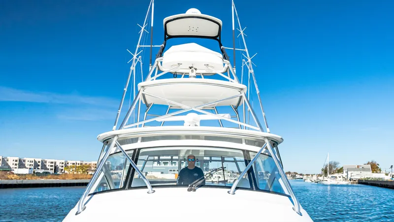  Yacht Photos Pics 2014 Viking 42 Open yacht on water, clear blue sky, marina background.