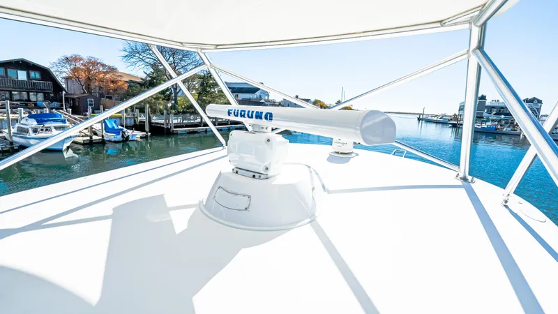  Yacht Photos Pics 2014 Viking 42 Open yacht with radar, docked in a scenic marina.