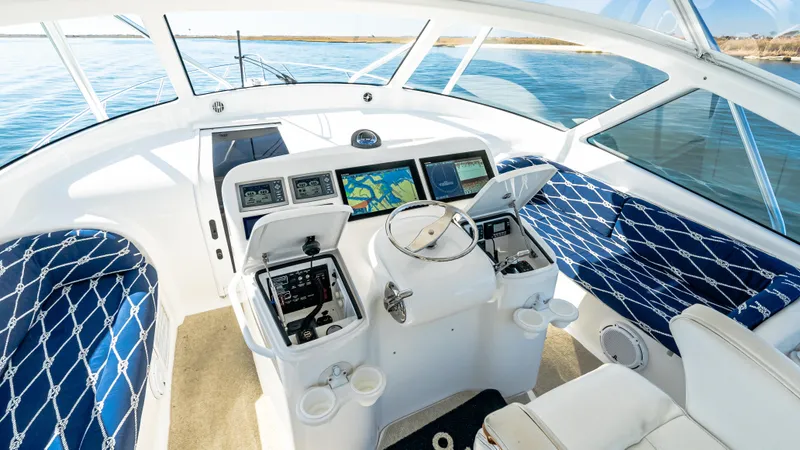  Yacht Photos Pics 2014 Viking 42 Open yacht cockpit with modern navigation systems and blue seating.