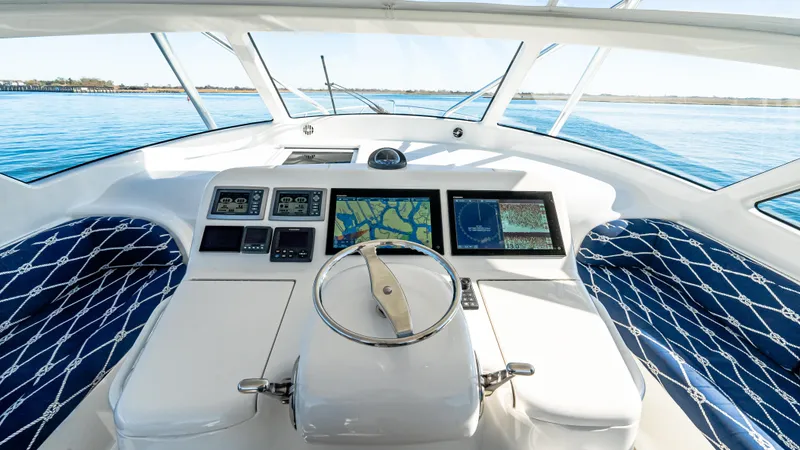  Yacht Photos Pics 2014 Viking 42 Open yacht helm with navigation screens and blue patterned seating.