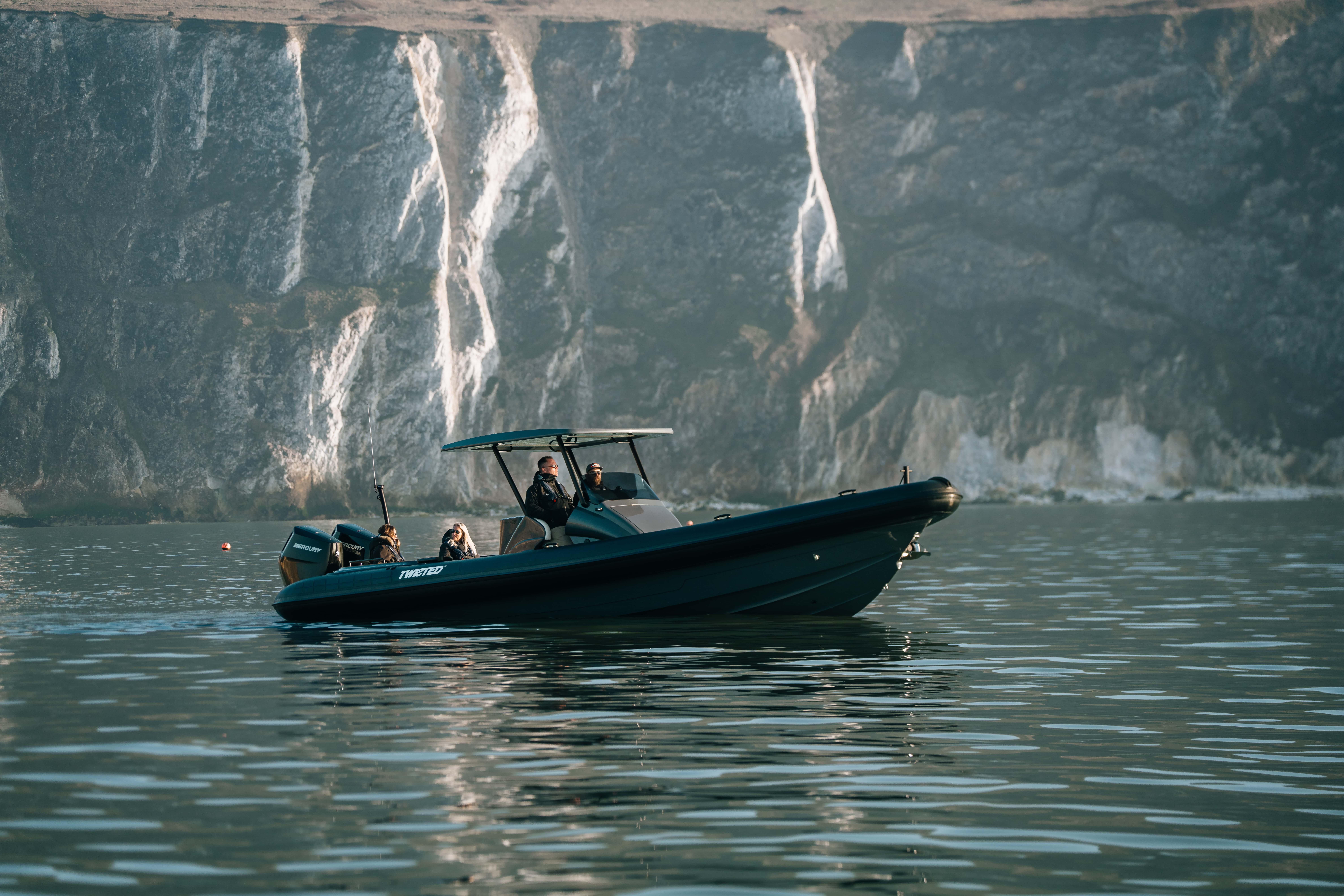 2025 Scorpion Grand Tourer 36 boat cruising near rocky cliffs.