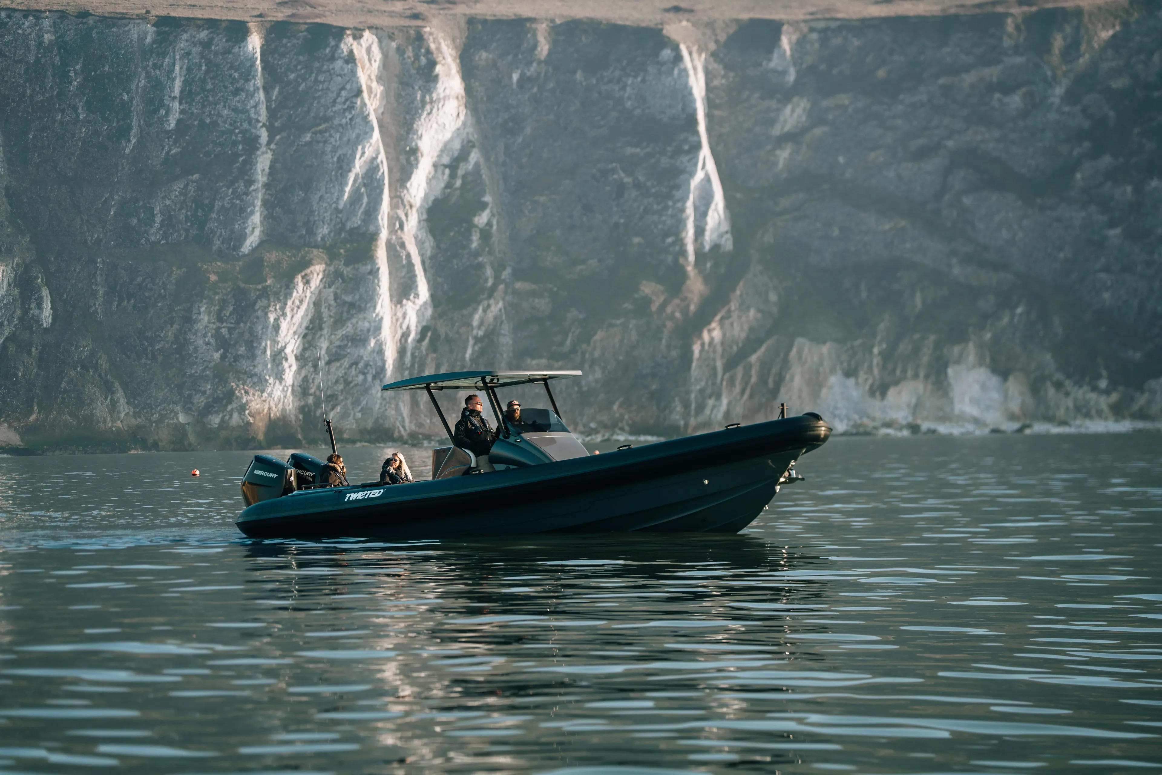2025 Scorpion Grand Tourer 36 boat cruising near rocky cliffs.